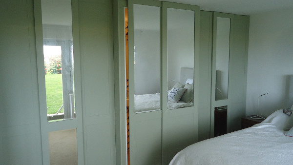 Sliding doors on an integrated En-Suite Shower room and wardrobe combination.